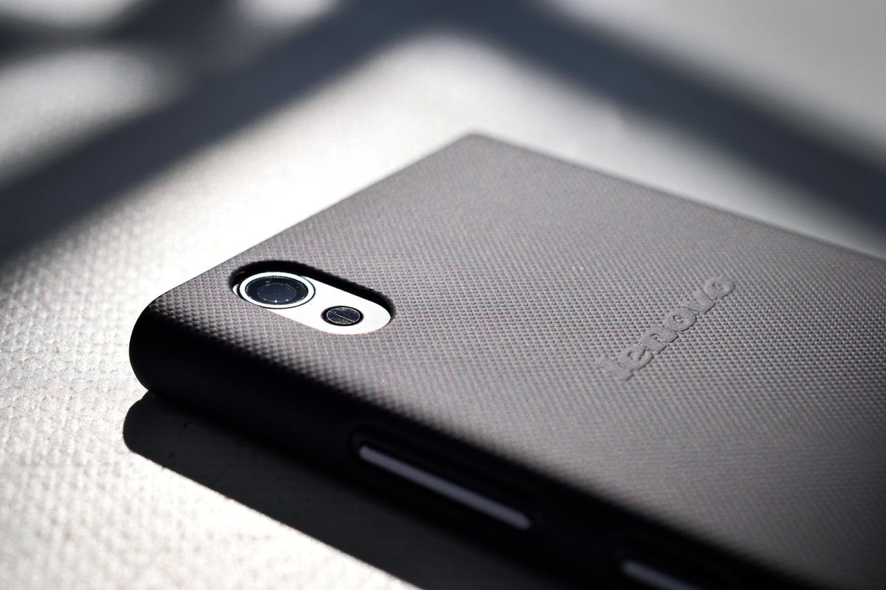 Detailed close-up view of a smartphone with a textured back cover emphasizing modern design and technology.